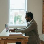 Working From Home - a person sitting at a desk with a laptop and papers